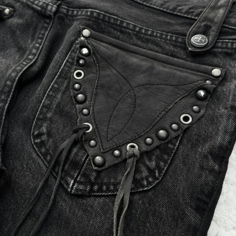 Washed denim jeans with decorative pockets